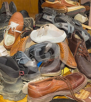 Pile of old different worn footwear