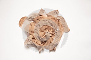 a pile of old dirty nylon brown socks on a white background, nylon sock, women's socks