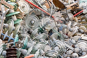 Pile of old high voltage electrical insulators made of glass, jicaras, and thrown away in a junkyard