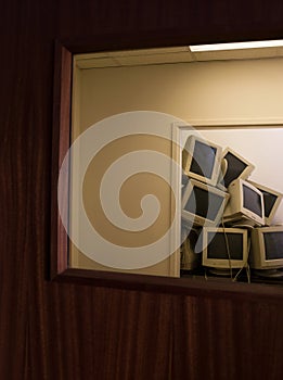Pile of Old Monitors in Empty Office