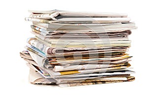 Pile of old newspapers and magazines, stacked, isolated on white background