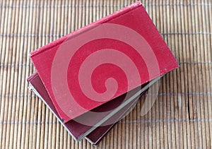 Pile of old red books with blank covers and copy space