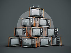 Pile of old retro TVs on dark background photo