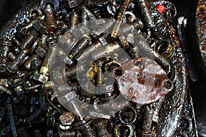 A pile of old rusty bolts that mess up engine oil at the old car spare parts market