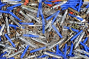 Pile of old rusty drive screws and dowels background, texture