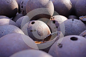 Pile of old rusty metal cannonballs