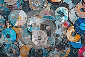 Pile of Old and Scratched CDs and DVDs in Various Conditions Representing Digital Storage Evolution photo