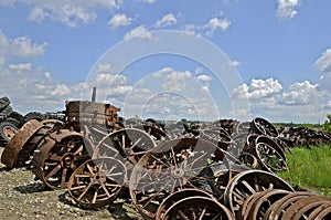 Pile of old steam engines wheels for salvage.