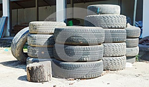 Pile of old tires neatly arranged. Old used tires stacked with high piles