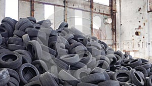 Pile of old tires stacked in junkyard panned up from base to top.