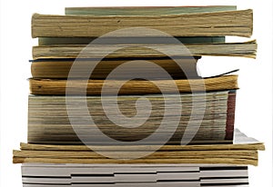 A pile of old and used books in front of a background with black-and-white bokeh, isolated