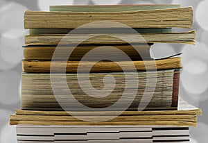 A pile of old and used books released and isolated against a white background