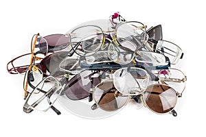 Pile of old used eye reading spectacles glasses on a white background. In studio