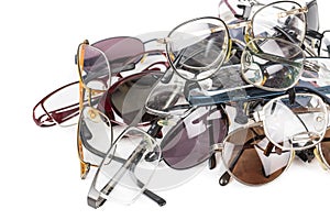 Pile of old used eye reading spectacles glasses on a white background. In studio