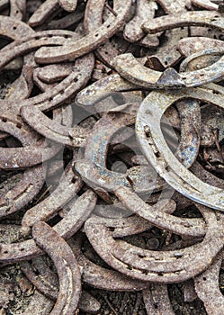 Pile of old used and rusty horseshoes