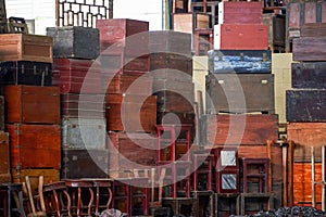 Pile of old vintage big wooden boxes stacked in a furniture store