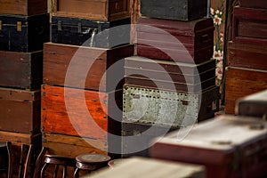 Pile of old vintage big wooden boxes stacked in a furniture store