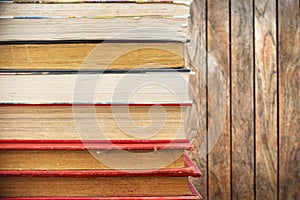 Pile of old vintage books, wooden background