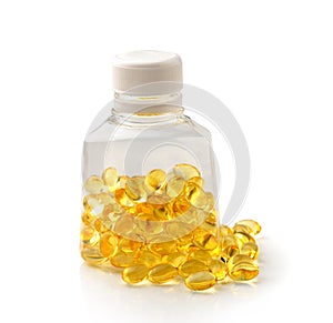 Pile of omega 3 fish oil capsules spilling out of a bottle