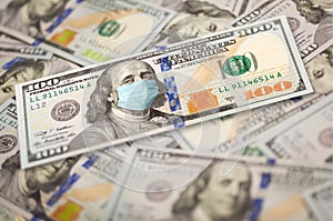 Pile of One Hundred Dollar Bills With Medical Face Mask on Face of Benjamin Franklin