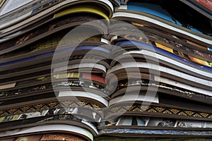 Pile of open magazines without texts seen from the side