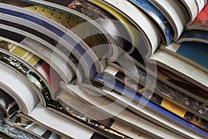 Pile of open magazines without texts seen from the side