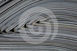 Pile of open magazines without texts seen from the side