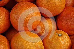 a pile of oranges with one of them on top