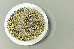 A pile of organic dried hemp seeds on a plate