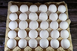 Pile of organic fresh and raw hen chicken white eggs, stack of eggs isolated and ready to be cooked in various cuisines, selective