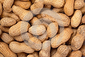 Pile of organic peanuts close-up. Peanut food background.