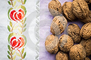 Pile of organic walnuts on vintage kitchen cloth, clean eating concept
