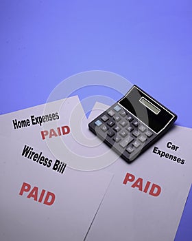 Pile of paid bills that occur on a regular basis for home and personal expenses