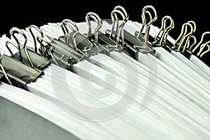 pile of paper documents in the office on black background