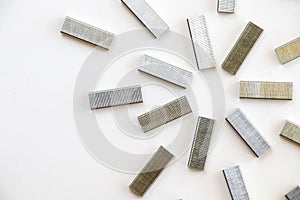 Pile of paper staples on white background