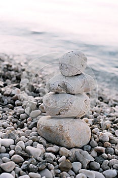 Pile of pebble stones over blue sea in the background