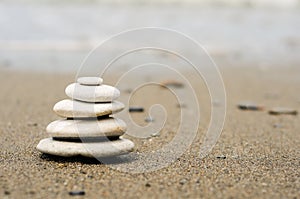 Pile of pebbles in the balance on the seacoast