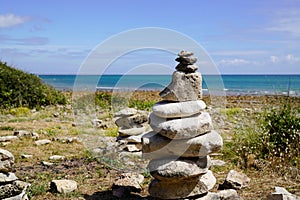 Pile of pebbles zen balanced stones stack on sea coast beach