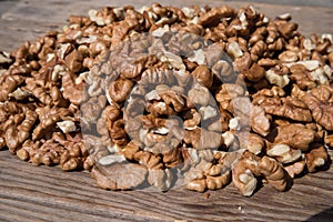 Pile of peeled walnuts isolated on a wooden background