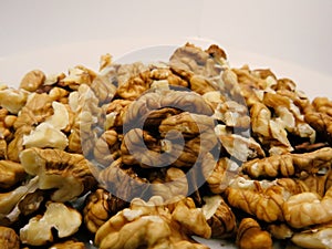 Pile of Peeled Walnuts on White Background.