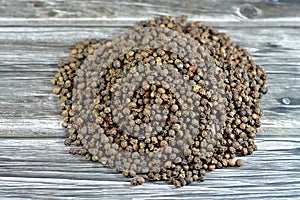 Pile of peppercorns, Black pepper (Piper nigrum), a flowering vine in the family Piperaceae, cultivated for its fruit