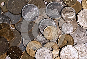 Cenital view of a pile of peseta coins with white background