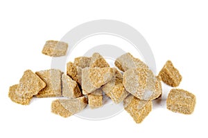 Pile of pieces of cane sugar isolated on white