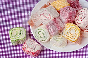 Pile of pieces of turkish delight lokum on a white background. Top view