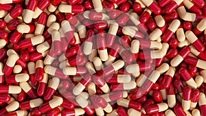 Pile of pills background, pill capsules in red and beige color. drug or vitamin capsules