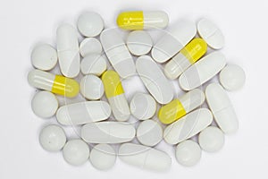 Pile of pills / capsules on white background