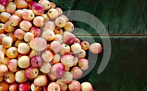 Pile of pink apple on banana leaf with space