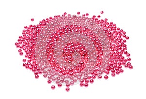Pile of pink beads on white background