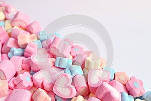 Pile of Pink Heart Shaped and Pastel Color Flower Shaped Marshmallow Candies with Free Space for Design or Text