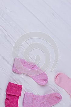 Pile of pink socks on wood with copyspace